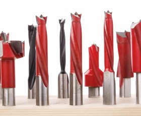 drill bits for wood standing on wooden stand on a white background